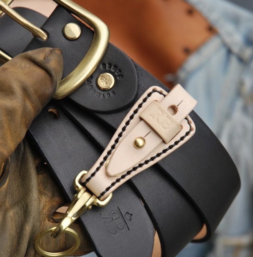 Hands working on a handmade leather product